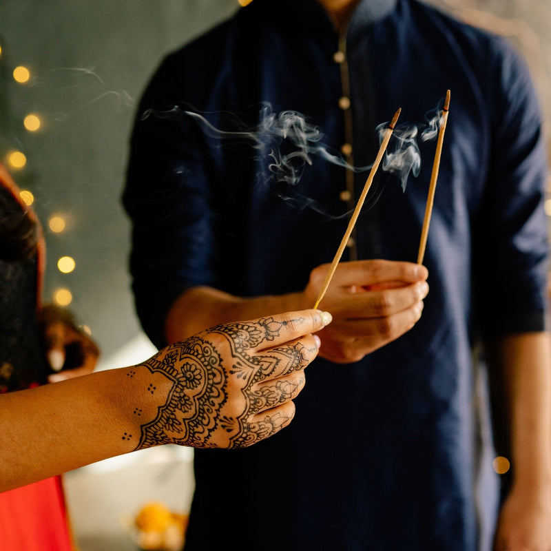 Couple holding incense 
