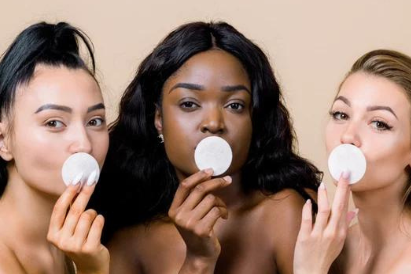 Women kissing cotton pads