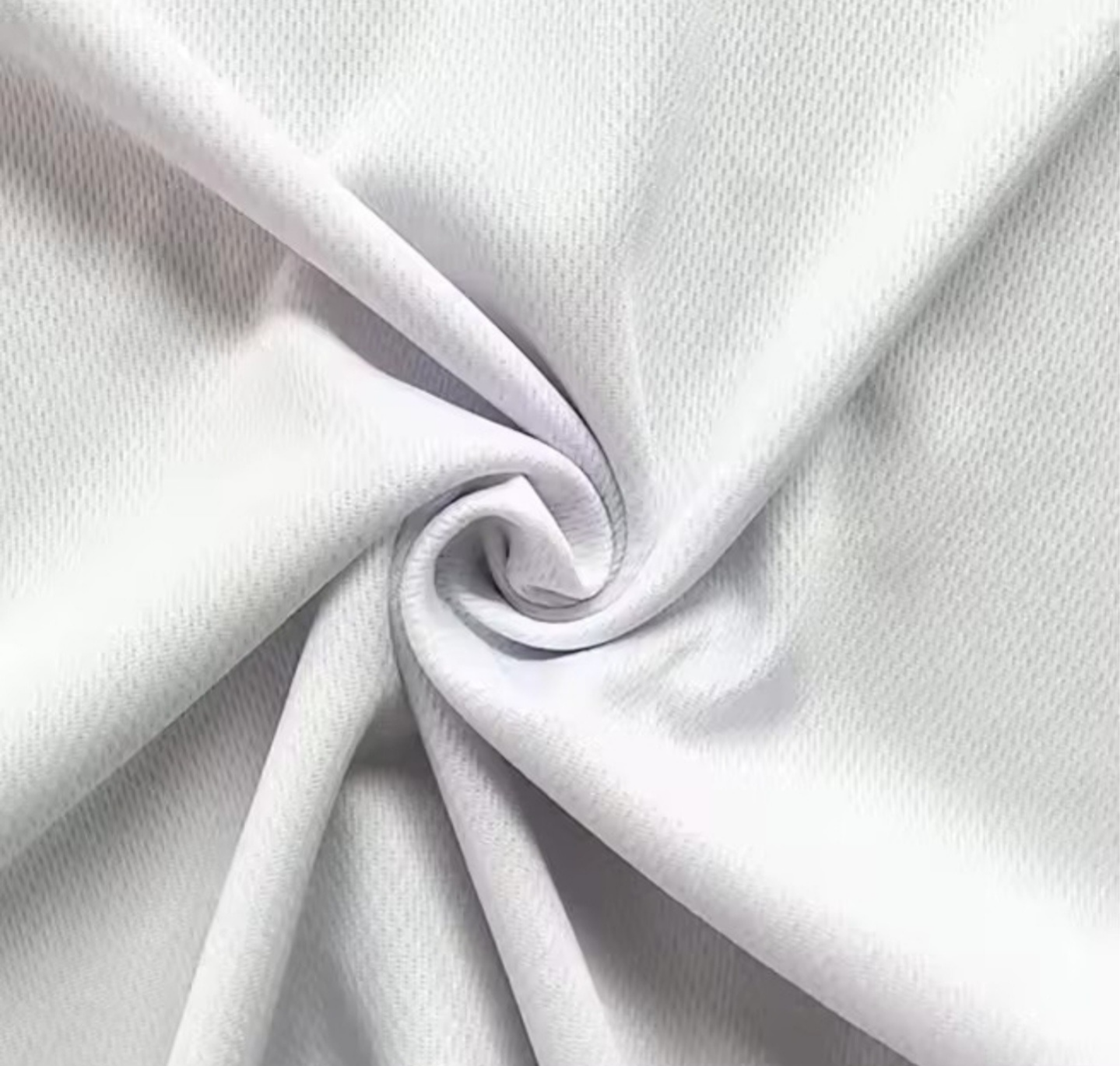 Close-up of white fabric with a swirl pattern