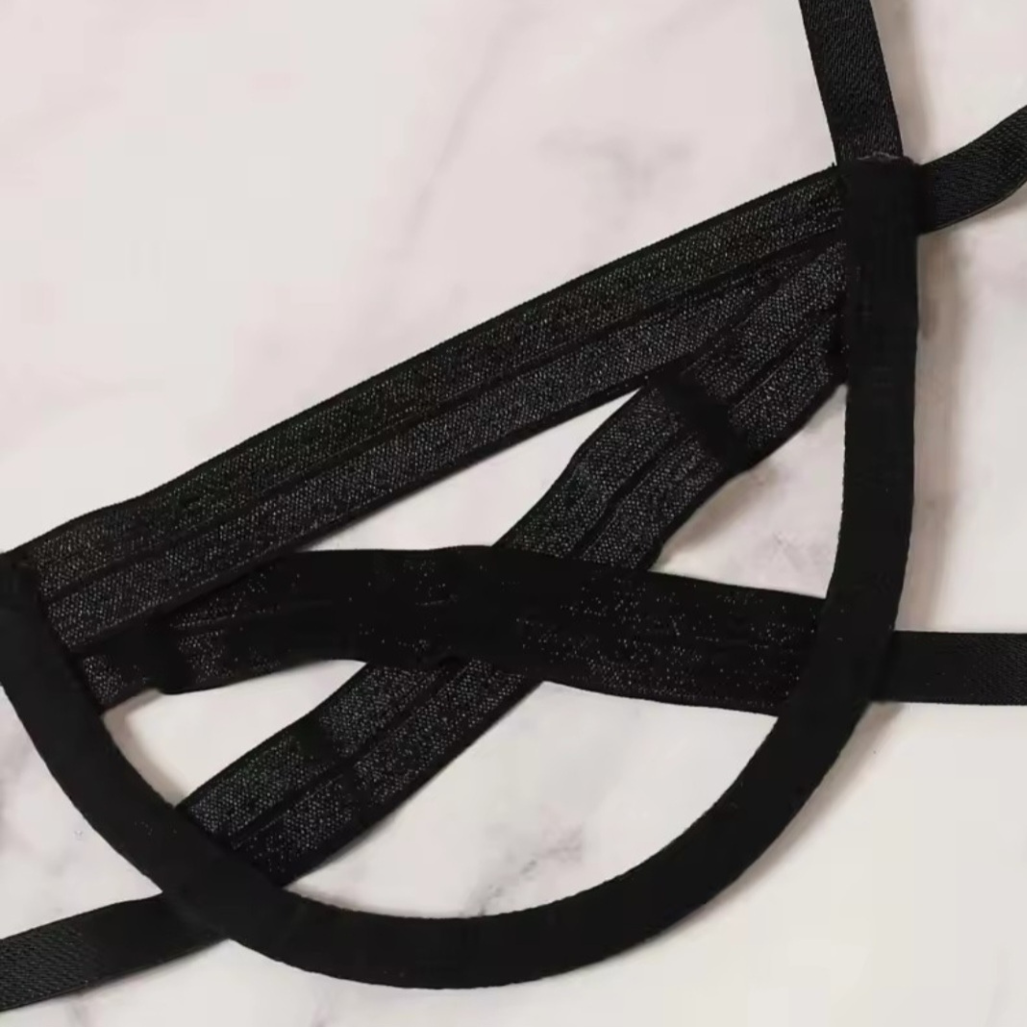 Black straps on a marble surface