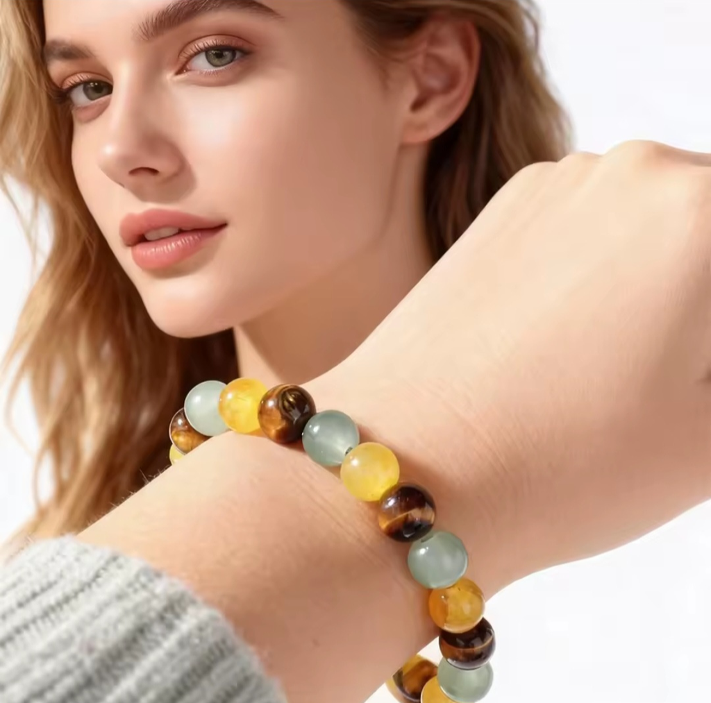 Close-up of a woman's hand wearing a colorful beaded bracelet on a white background