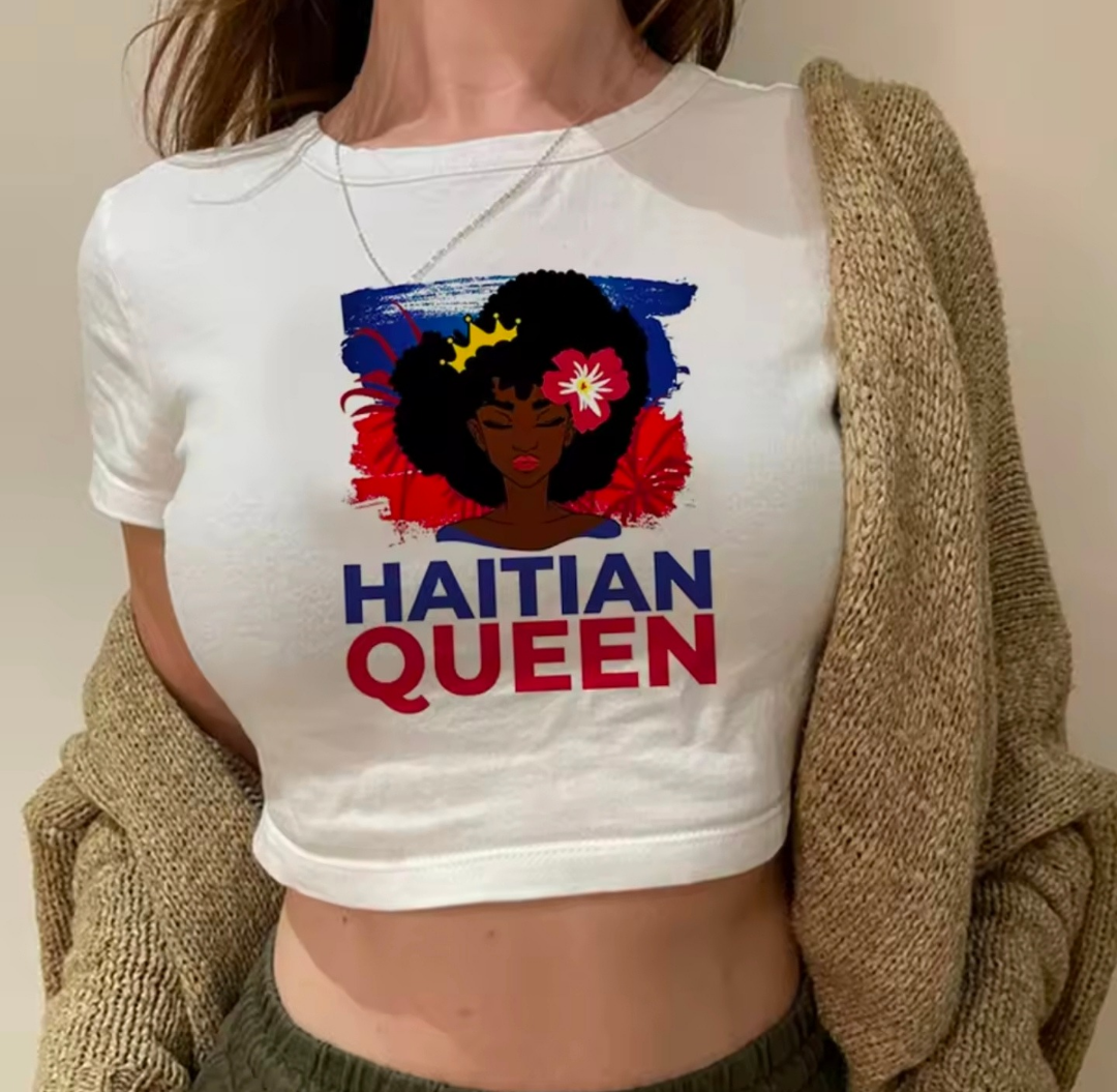 Person wearing a white t-shirt with 'Haitian Queen' design