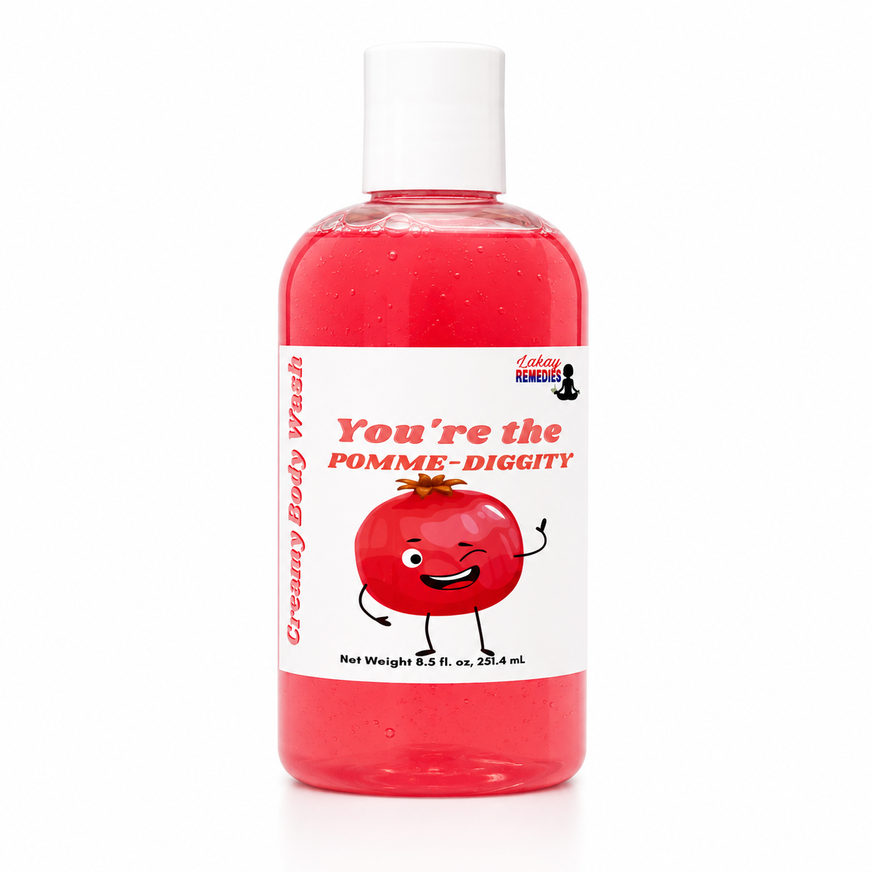 A bottle of Lakay Remedies 'You're the Pomme-Diggity' creamy body wash, featuring a red liquid inside a clear bottle with a white cap and a white label with a cartoon pomegranate.