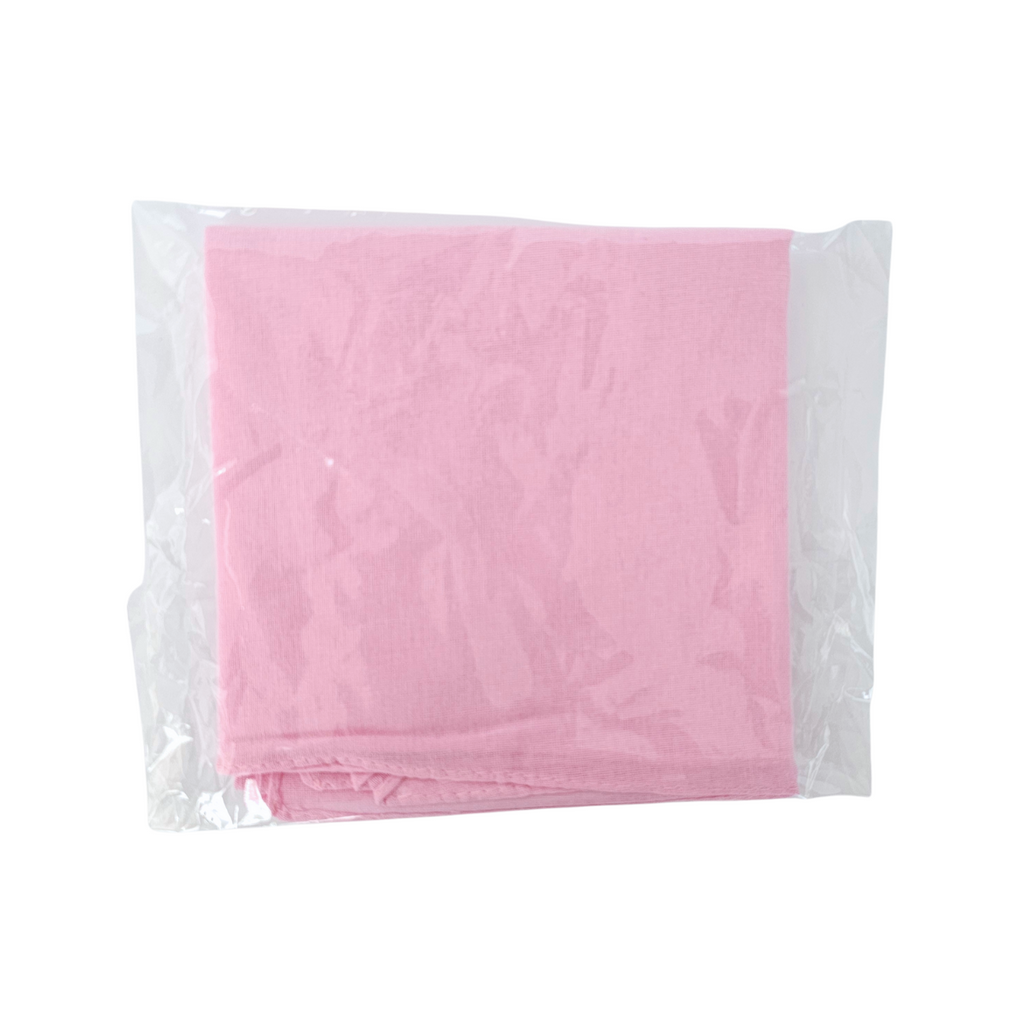 Pink fabric Spiritual Mouchwa in a clear plastic bag on a white background