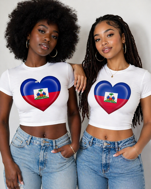Two women wearing white t-shirts with a heart-shaped Haiti flag design, standing against a plain background.