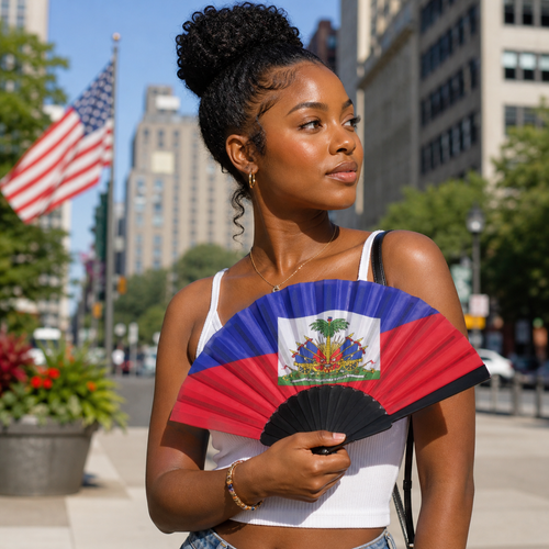 Woman holding a Haitian flag fan in an urban setting