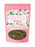 Pink stand-up pouch of 'Bring On the Milk Tea' herbal breastfeeding tea blend, featuring a colorful botanical pattern label and a clear window showing the dried tea leaves inside.