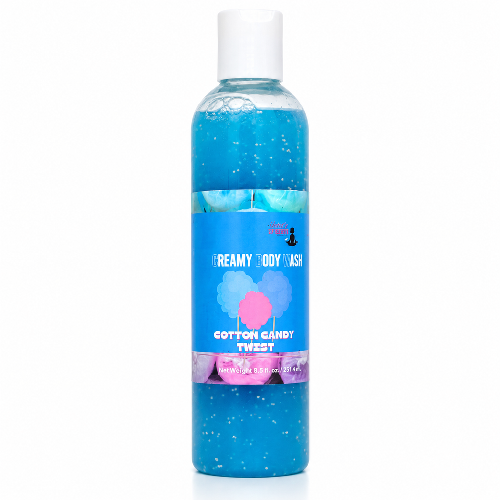 A bottle of body wash with blue gel inside, featuring a white cap and a blue label with pink and white text that reads 'Creamy Body Wash' and 'Cotton Candy Twist'.