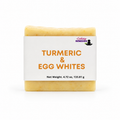 A bar of soap labeled 'Turmeric & Egg Whites' by Lakay Remedies, featuring a white paper label with orange text and a yellow-turmeric soap bar visible at the top and bottom, on a white background.