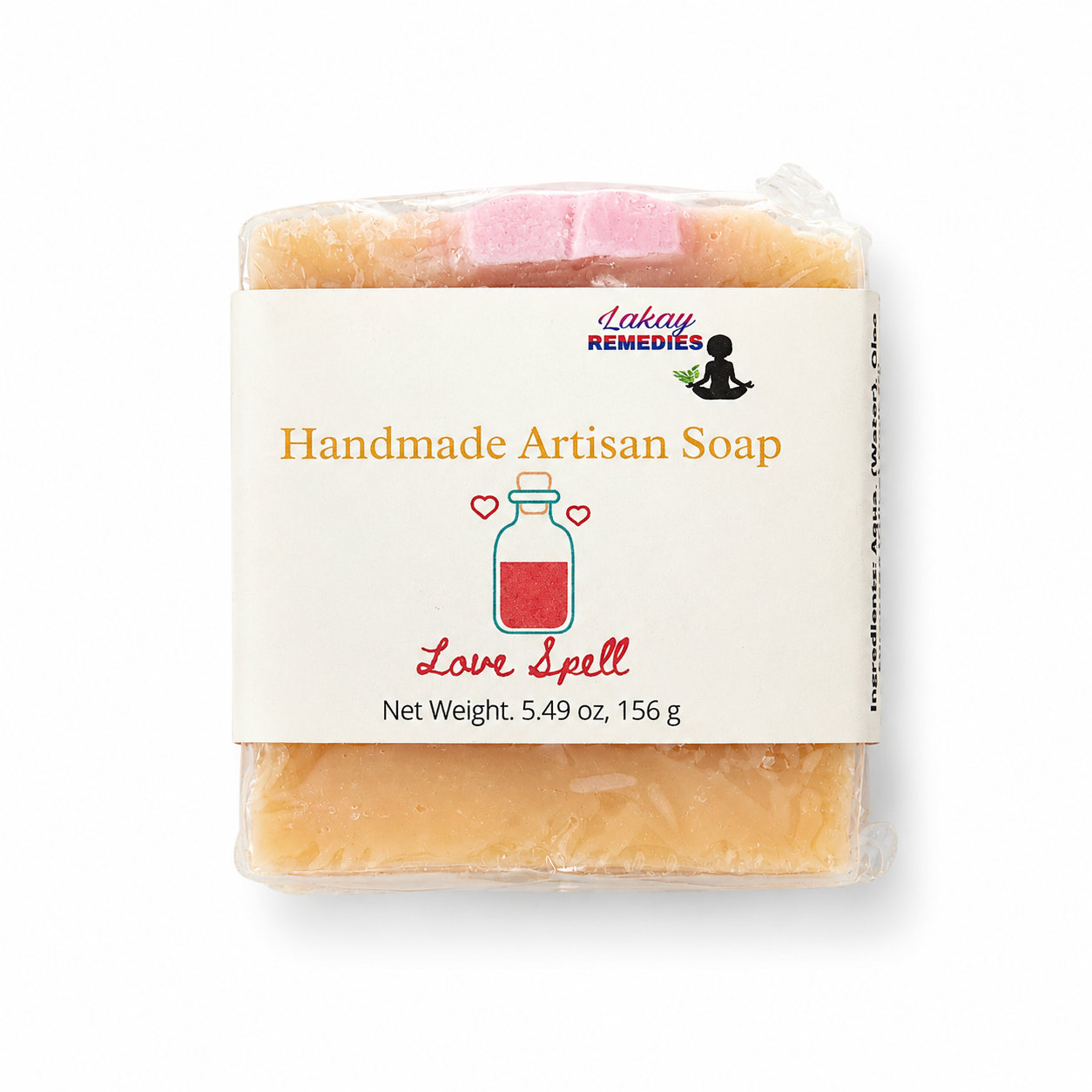 A packaged bar of handmade artisan soap labeled 'Love Spell' by Lakay Remedies, wrapped in clear plastic with a cream paper label, on a white background.