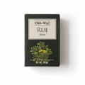 A rectangular black box of Ohli-Way Rue Soap, featuring a cream-colored label with the brand name and a botanical illustration of green leaves and small yellow flowers, set against a plain white background.