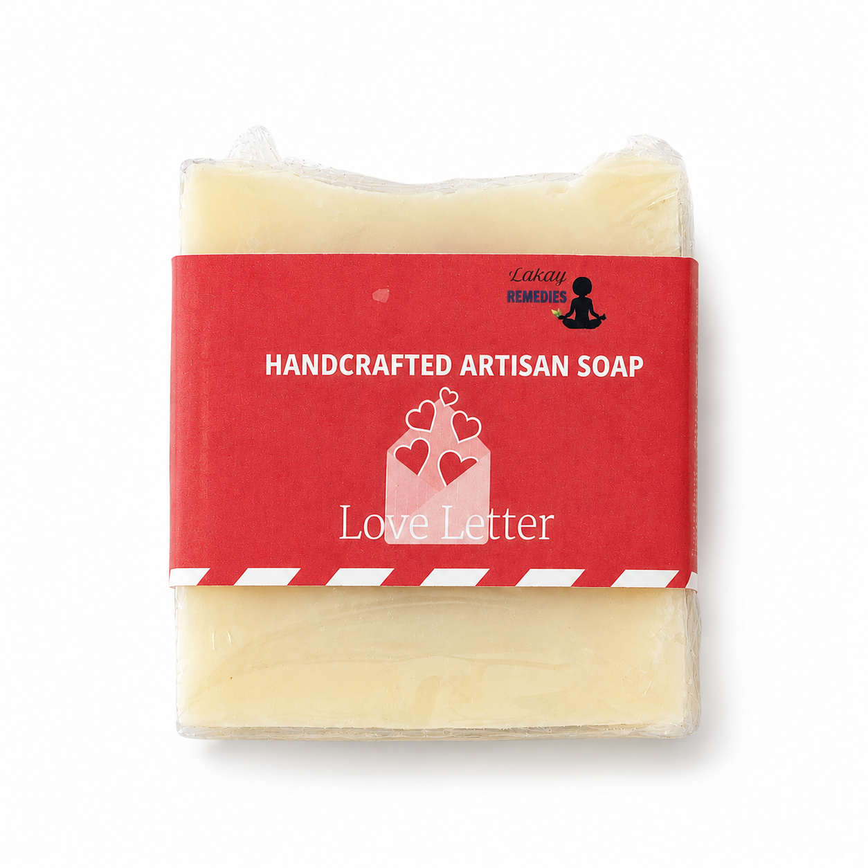 A handcrafted artisan soap bar wrapped in clear plastic with a red paper label that reads 'HANDCRAFTED ARTISAN SOAP' and 'Love Letter,' on a white background.