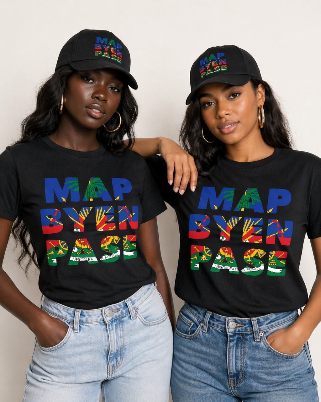 Two women wearing black t-shirts with colorful text and black caps, standing against a plain background.