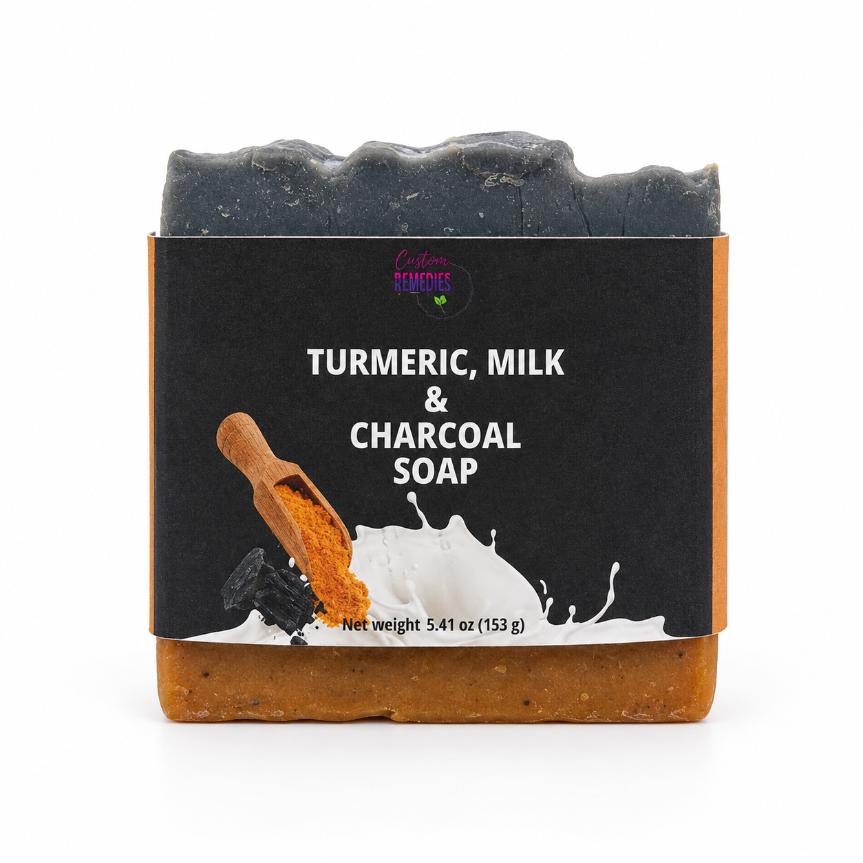 A bar of Turmeric, Milk & Charcoal Soap by Lakay Remedies, featuring a dark charcoal gray top and a warm brown base, wrapped in a black label with white text and an illustration of a wooden scoop of turmeric.