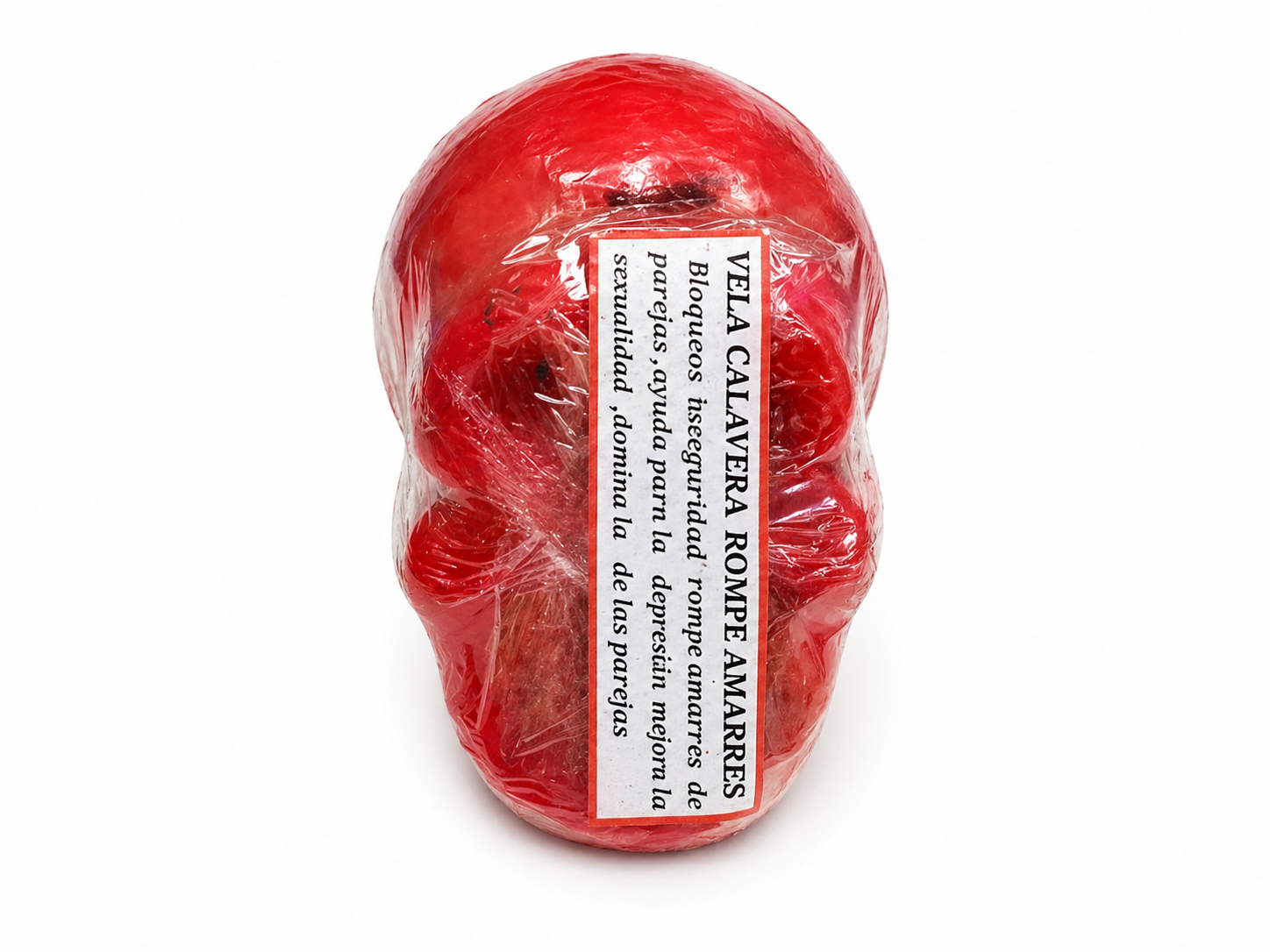 Red skull-shaped candle wrapped in clear plastic with a white label on a white background