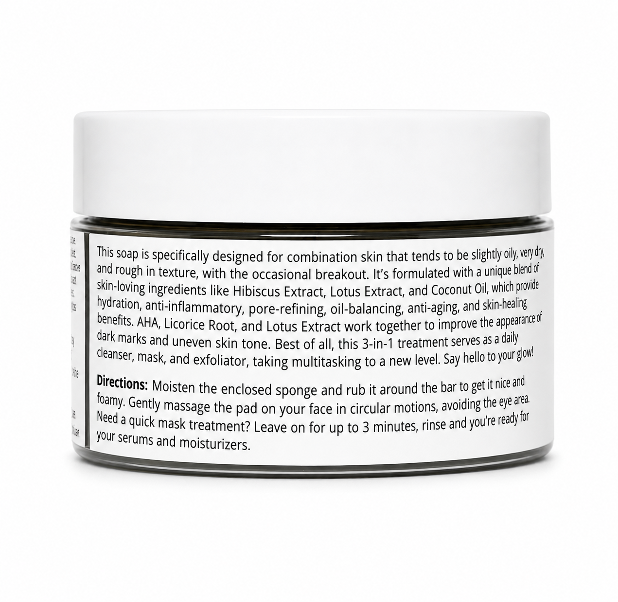 A white cylindrical jar of facial cleanser with a black label, photographed on a clean white background. The label contains detailed product information, including scent notes of hibiscus, lotus, and coconut oil, and usage directions.