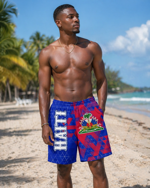 Man wearing a colorful swimsuit with 'Haiti' text on a beach