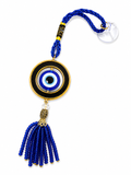 Evil eye charm with blue beads on a white background