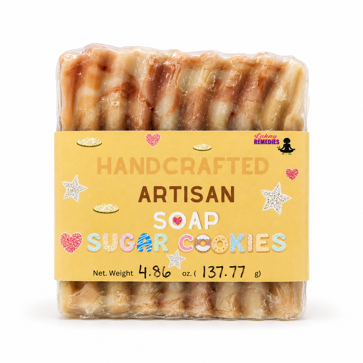 A packaged bar of handmade artisan soap shaped like sugar cookies, wrapped in clear plastic with a yellow label reading 'HANDCRAFTED ARTISAN SOAP SUGAR COOKIES' and 'Lakay Remedies' at the top right, on a white background.