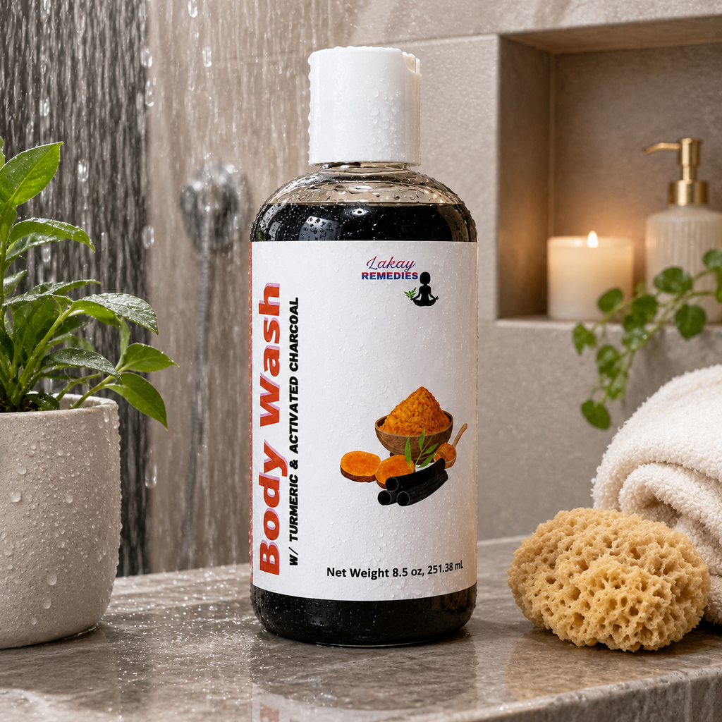 A bottle of body wash with a white cap and white label stands on a bathroom counter. The label reads 'Body Wash' and shows turmeric and charcoal imagery.