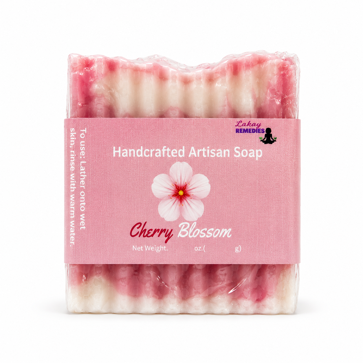 A packaged bar of handcrafted artisan soap labeled 'Cherry Blossom' by Lakay Remedies, wrapped in clear plastic with a pink paper band showing a cherry blossom flower graphic.