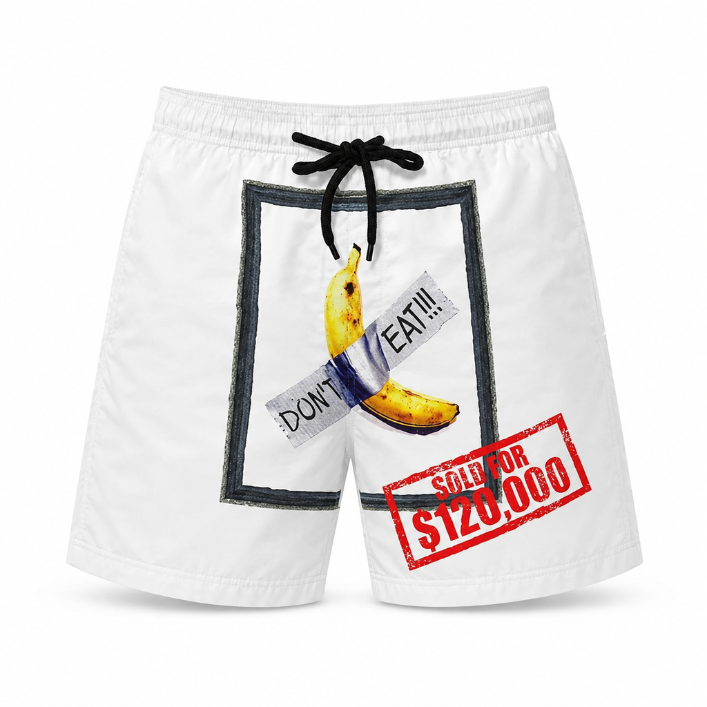 White men’s swim shorts on a plain white background featuring a banana graphic taped with “DON’T EAT!!!” text and a red “SOLD FOR $120,000” stamp design.