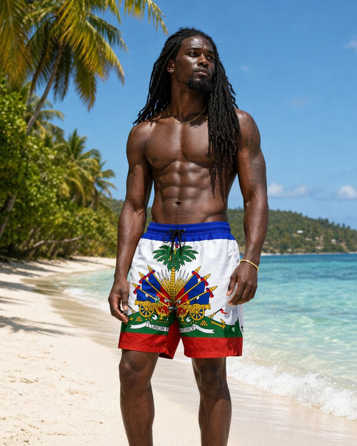 Man wearing  haiti themed beach shorts with a tropical design on a beach.