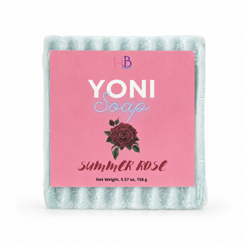 A packaged bar of Yoni Soap in the Summer Rose scent, featuring a light blue-green textured soap bar wrapped in clear plastic with a pink paper label.