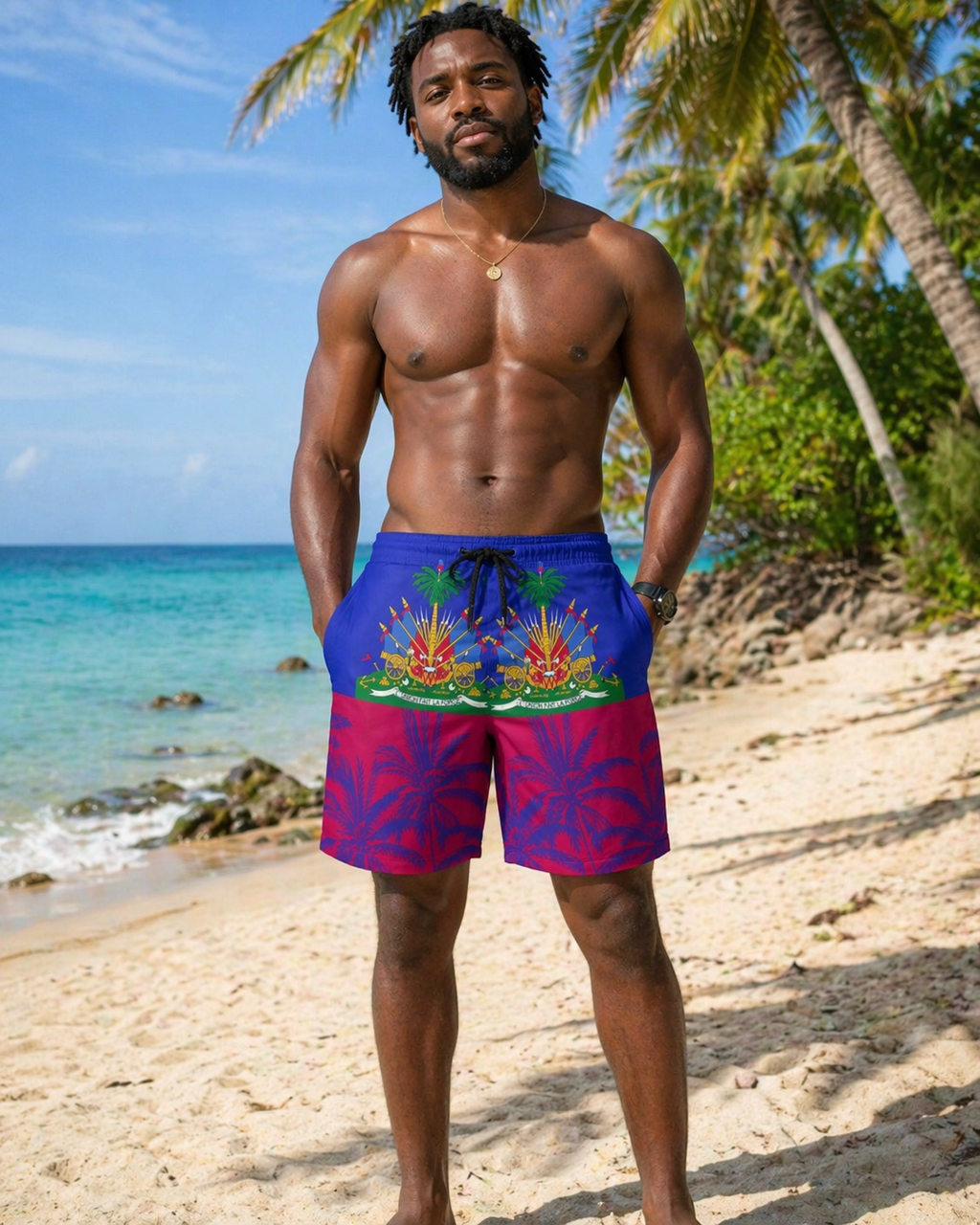 Man wearing colorful tie-dye shorts standing on a beach with palm trees and ocean in the background