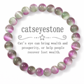 Catseyestone bracelet with purple and green beads on a white background