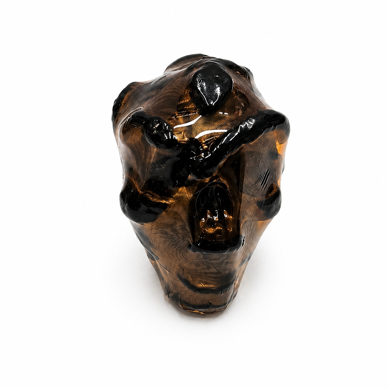 Black skull sculpture candle on a white background