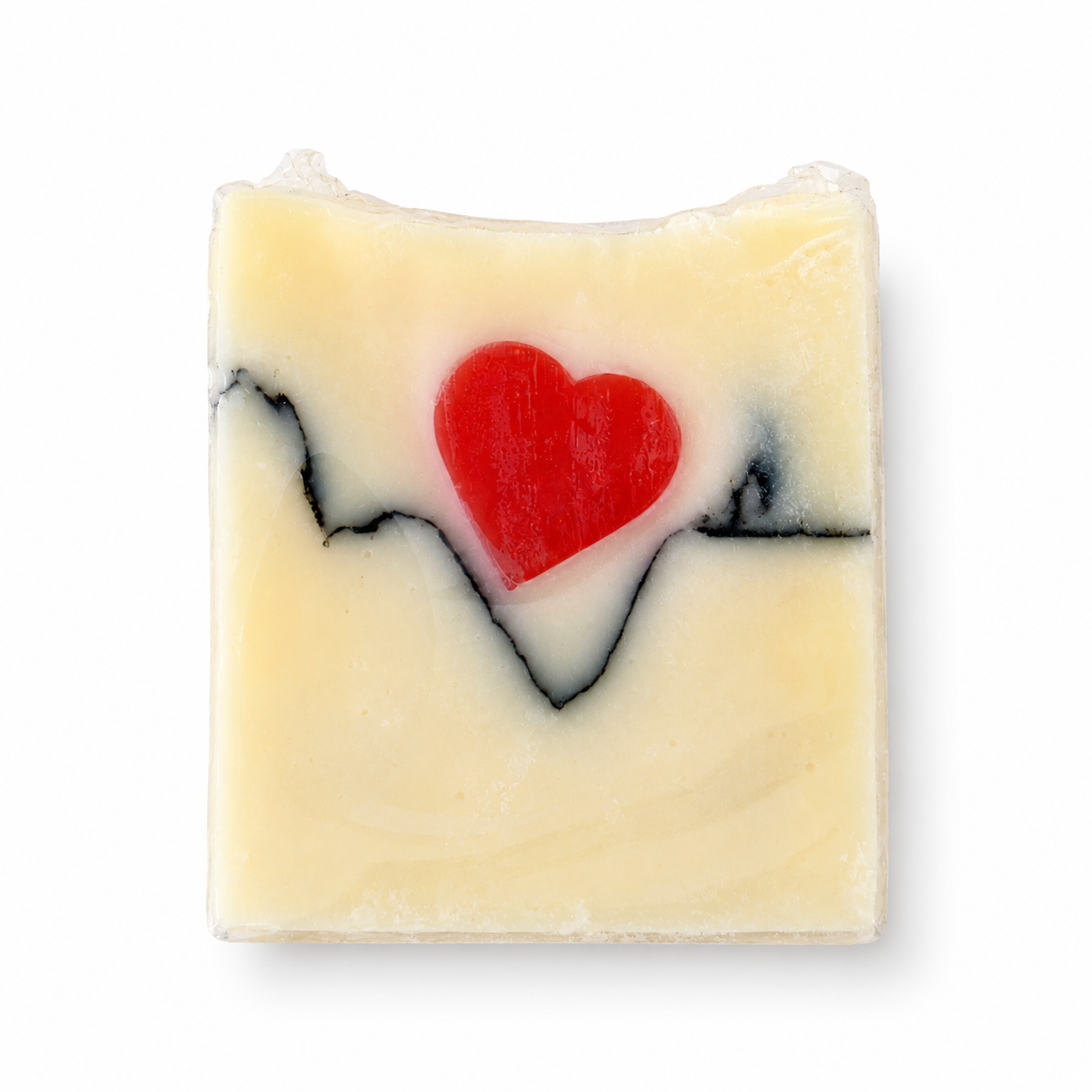 A rectangular bar of handmade soap with a pale cream base, featuring a black heartbeat line pattern and a red heart in the center, shown on a plain white background.