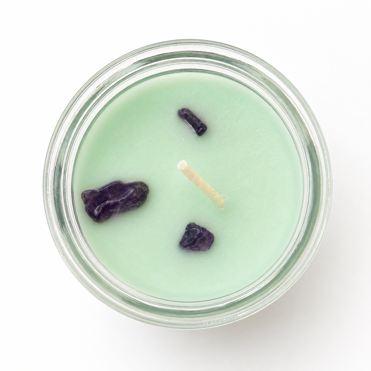 Candle with stones on a white background