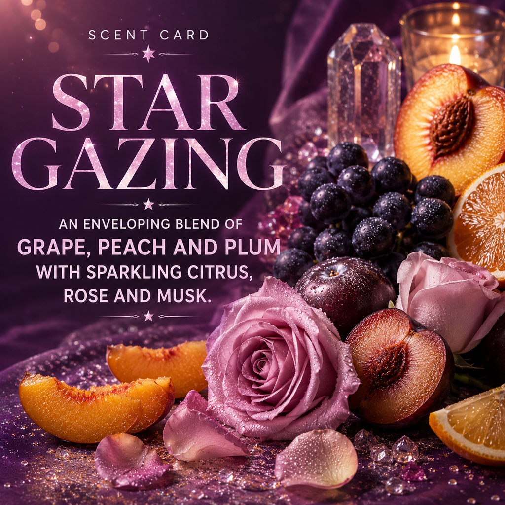 Scent card graphic for 'Star Gazing' featuring a purple-toned still life with a pink rose, peach slices, plums, grapes, citrus, crystals, and a lit candle. Text reads: 'SCENT CARD STAR GAZING' and 'AN ENVELOPING BLEND OF GRAPE, PEACH AND PLUM WITH SPARKLING CITRUS, ROSE AND MUSK.