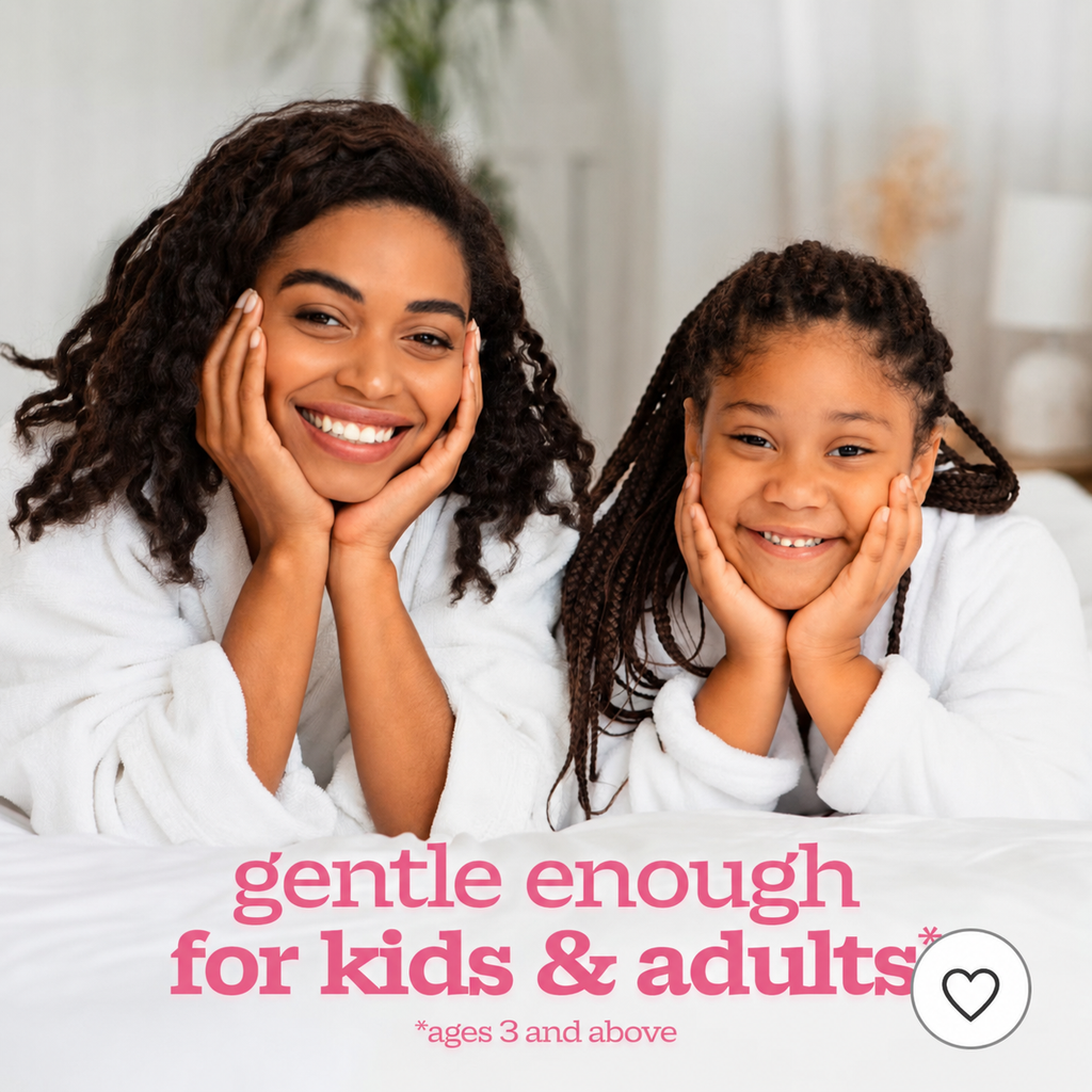 A smiling woman and a young girl in matching white robes or bedsheets pose together in a softly lit indoor setting, with pink text at the bottom reading 'gentle enough for kids & adults' and smaller text 'ages 3 and above'.