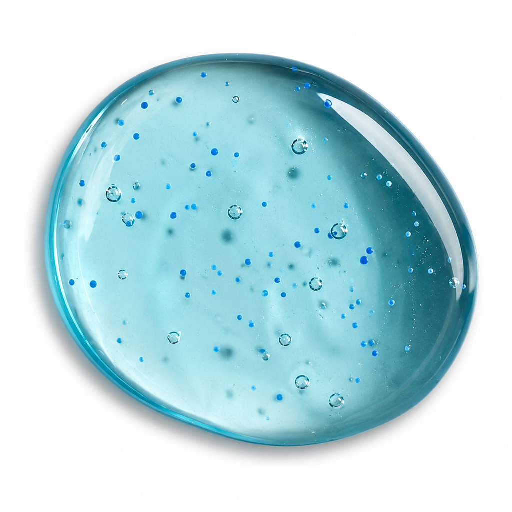 A translucent light blue body wash gel circular product with scattered blue glitter and small bubble details, shown on a plain white background.