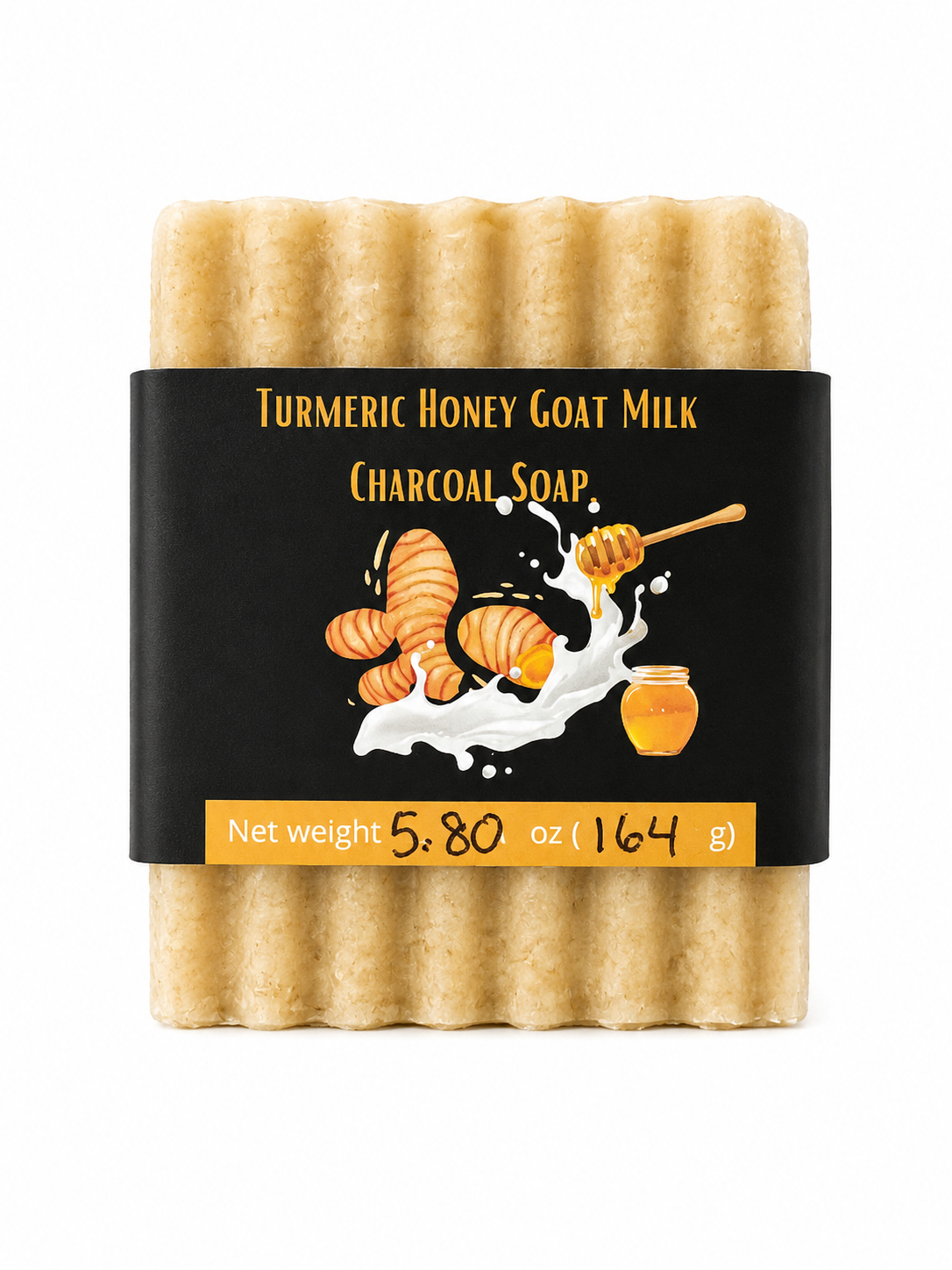 A pack of four goat milk soap bars wrapped in a black paper band. The soaps are a light, warm tan color, and the label features illustrations of turmeric root, honey, and goat milk, with the text 'Turmeric Honey Goat Milk Charcoal Soap'.