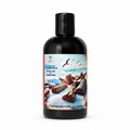 A bottle of  Sea Salt & Driftwood  Shower & Bubble Bath, 9.5 fl oz (280 ml), featuring a black bottle with a colorful label depicting a beach scene with driftwood and birds.
