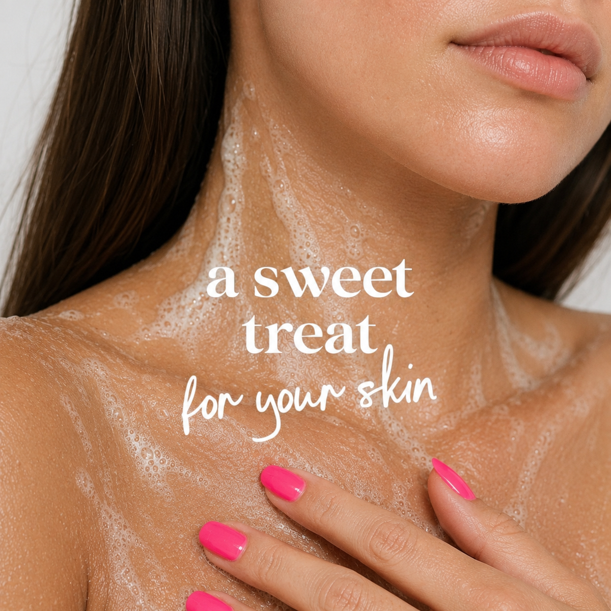 Close-up of a woman's neck and upper chest covered in white foaming skincare product, with her hand resting on her shoulder. White text overlay reads 'a sweet treat for your skin'.