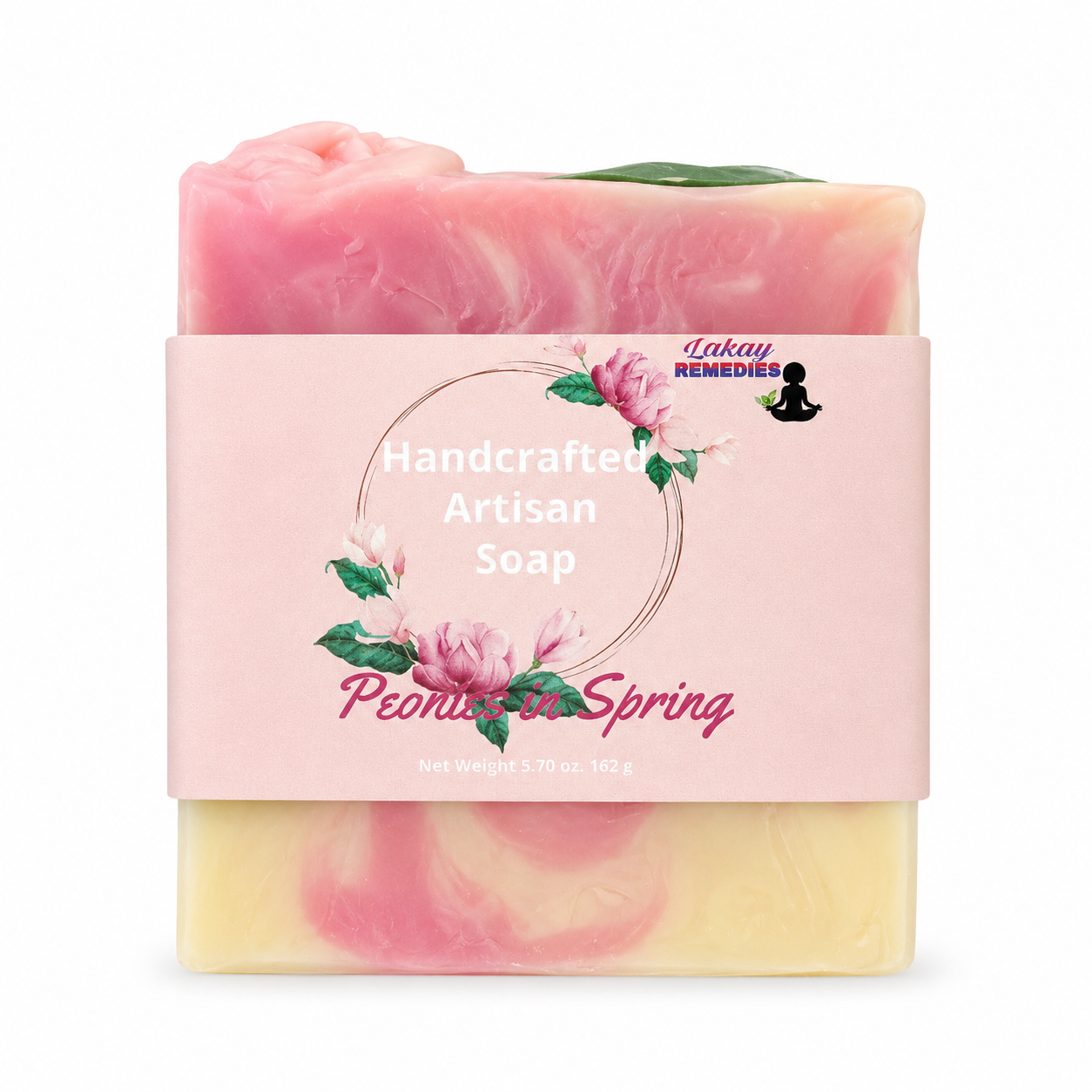 A handcrafted artisan soap bar wrapped in a pink paper label that reads 'Handcrafted Artisan Soap Peony & Spring' with 'Lakay Remedies' logo. The soap has a swirled pink and pale yellow color, with a green leaf detail on top, shown against a plain white background.