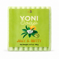 A square bar of Yoni Soap in the 'Juicy & Nutty' scent, wrapped in clear plastic with a bright lime-green paper label. The label features the brand initials 'HB' at the top, the text 'YONI Soap' in white, a graphic of green leaves, a white flower, and a nut, and the scent name 'Juicy & Nutty' in orange.