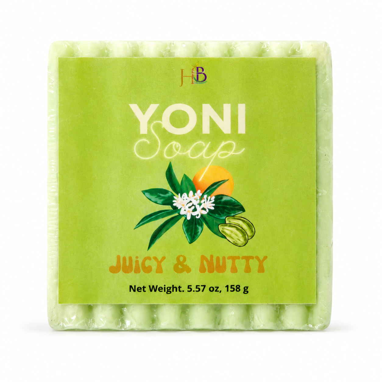A square bar of Yoni Soap in the 'Juicy & Nutty' scent, wrapped in clear plastic with a bright lime-green paper label. The label features the brand initials 'HB' at the top, the text 'YONI Soap' in white, a graphic of green leaves, a white flower, and a nut, and the scent name 'Juicy & Nutty' in orange.