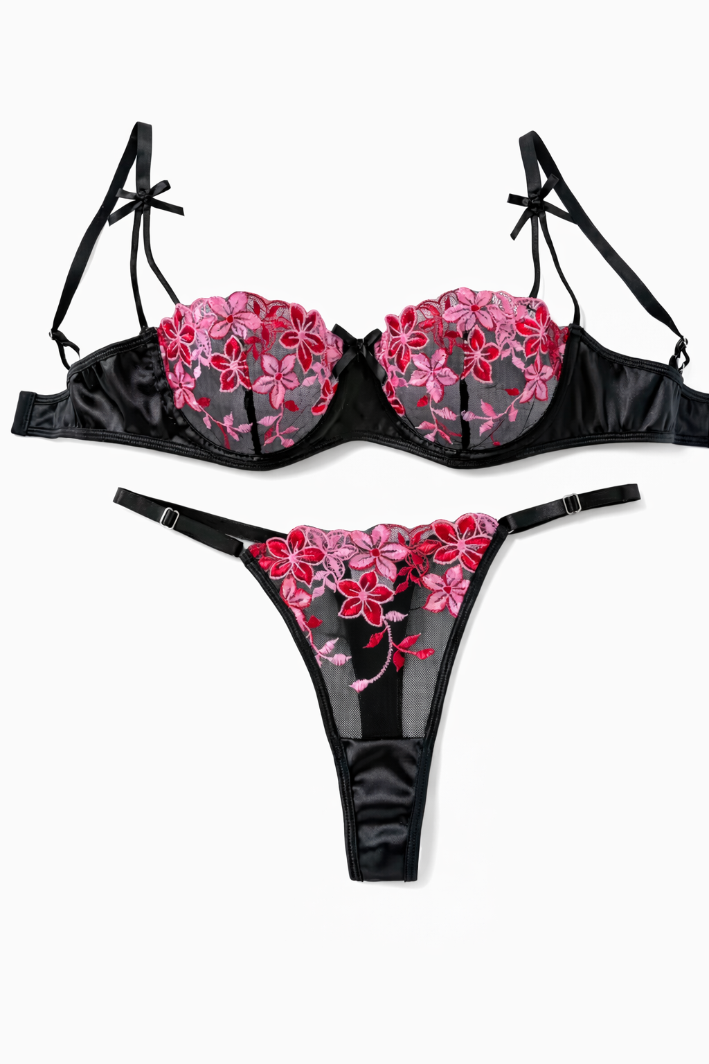 Black lingerie set with pink floral embroidery on a white background