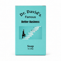 A rectangular turquoise soap bar package labeled 'Dr. David's Famous Better Business Soap' with a small illustration of a seated figure on white stairs, shown on a plain white background.