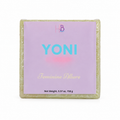 A square wrapped bar of soap with a lavender label reading 'YONI' and 'Feminine Allure,' photographed on a plain white background.