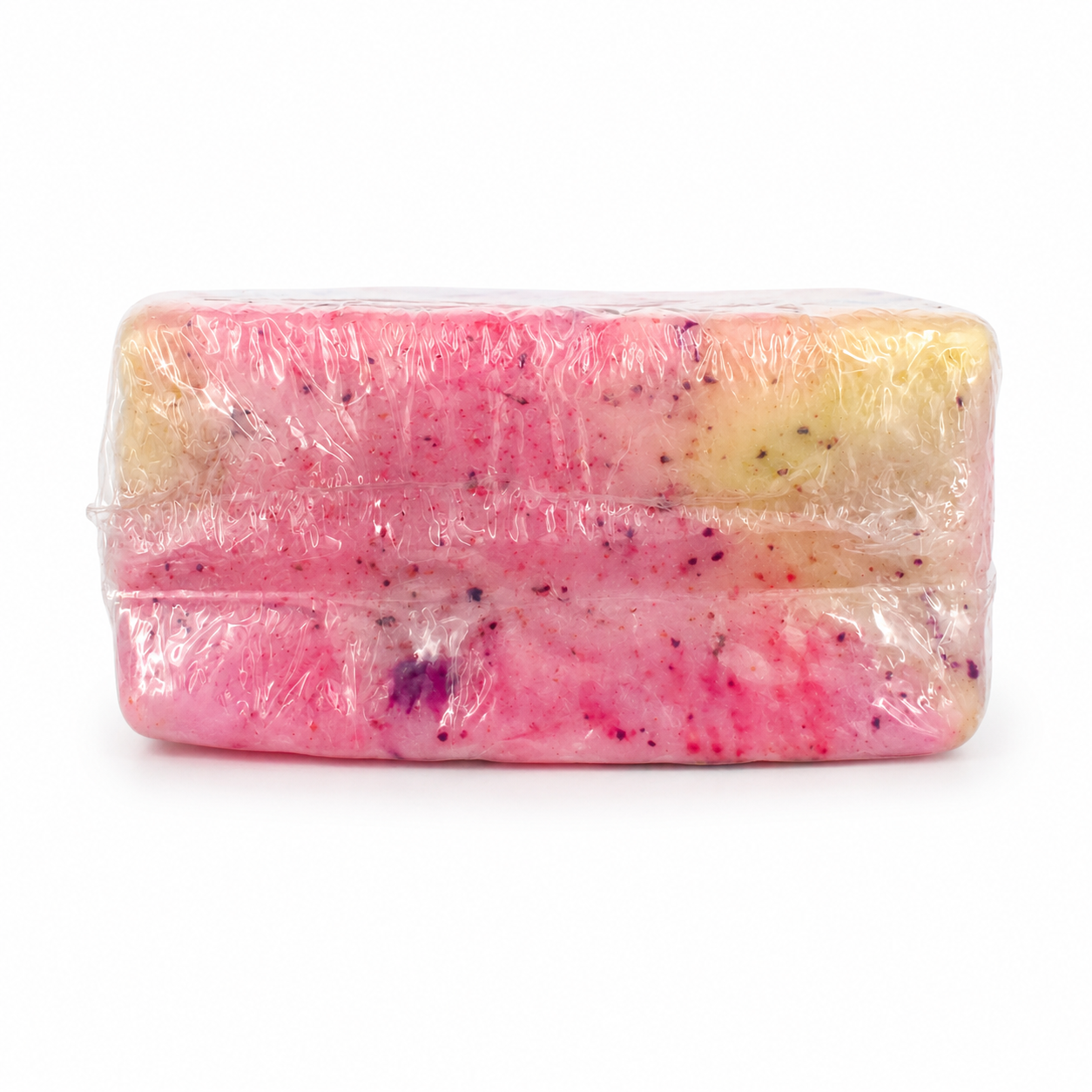 A rectangular bar of soap wrapped in clear plastic, showing a pink and pale yellow marbled pattern with small purple specks, on a white background.