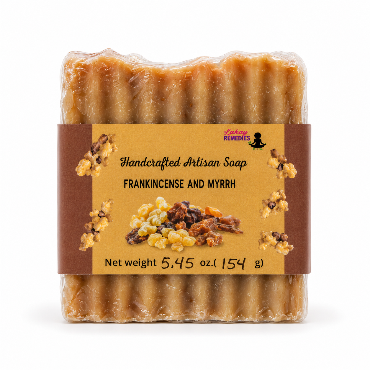 A packaged bar of handmade artisan soap labeled 'Frankincense and Myrrh' , wrapped in clear plastic with a tan and brown paper label, on a white background.