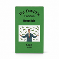 A green rectangular box of Dr. David's Famous Money Rain Soap, 3oz (85g), featuring the brand name and a cartoon illustration of a man in a suit surrounded by falling dollar bills.