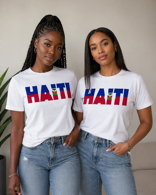 Two women wearing white t-shirts with 'HAITI' printed on them, standing indoors.