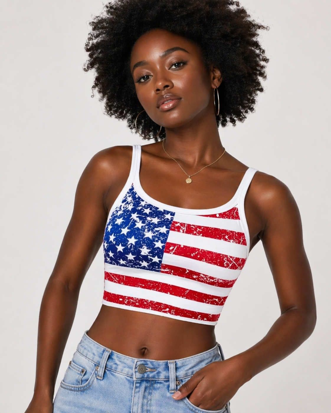 Woman wearing a tank top with an American flag design on a plain background